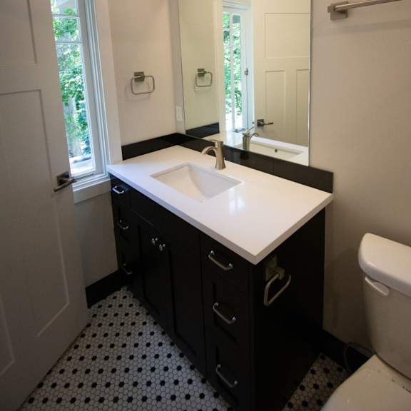 a white sink in a black and white bathroom.