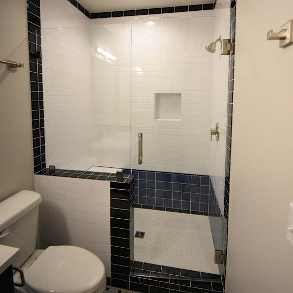 a bathroom with a toilet, sink, and mirror.