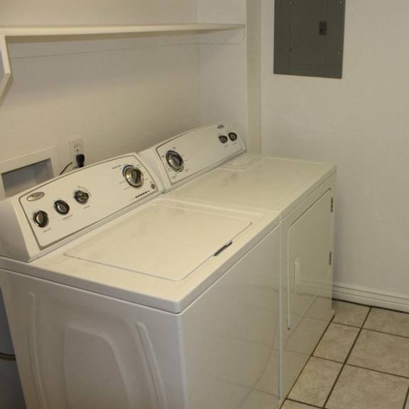 a white washer and dryer in a small laundry room.