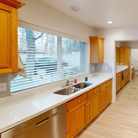 a kitchen with wooden cabinets and stainless steel appliances.