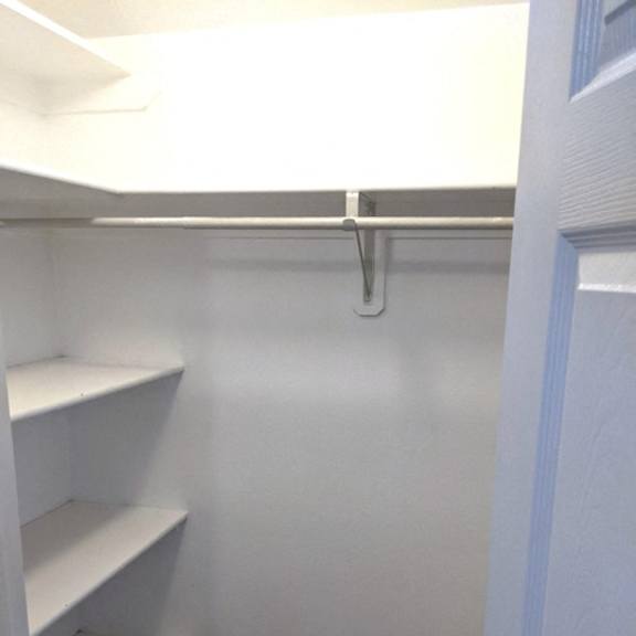 empty white shelves in a room.