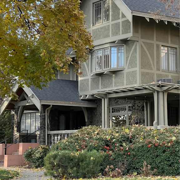 a house with a grey roof and a balcony.