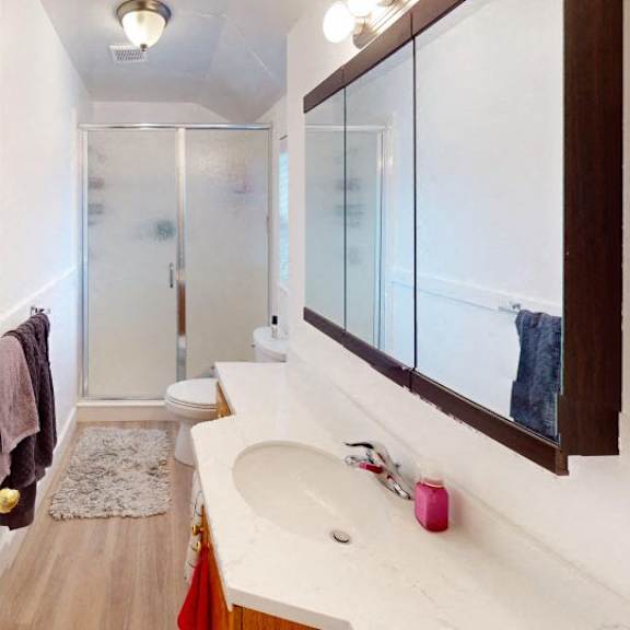 a bathroom with a white sink and a mirror.