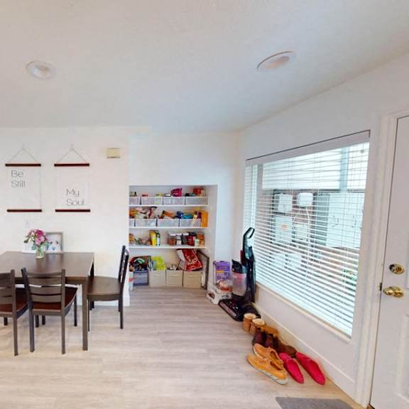 a dining room with a table and chairs.