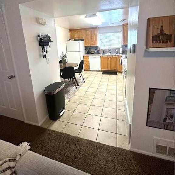 a kitchen with a dining table and chairs is visible from the living room.