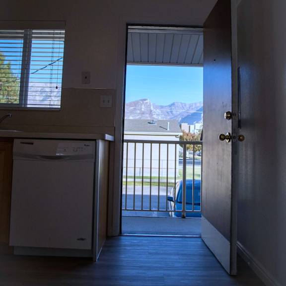 a view of the mountains is visible through the open door.