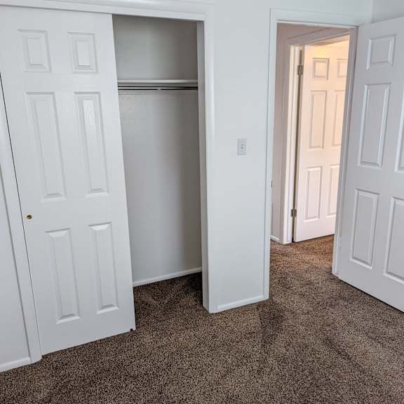 a white door is open to a hallway.