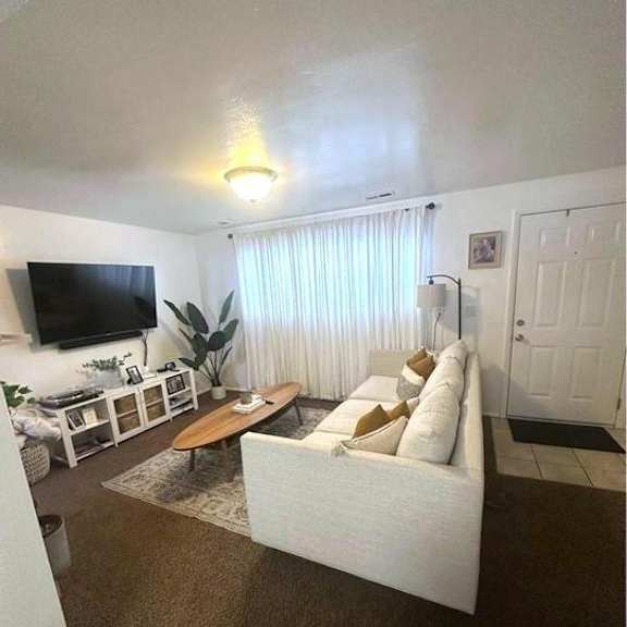 a living room with a white couch and a flat screen tv.