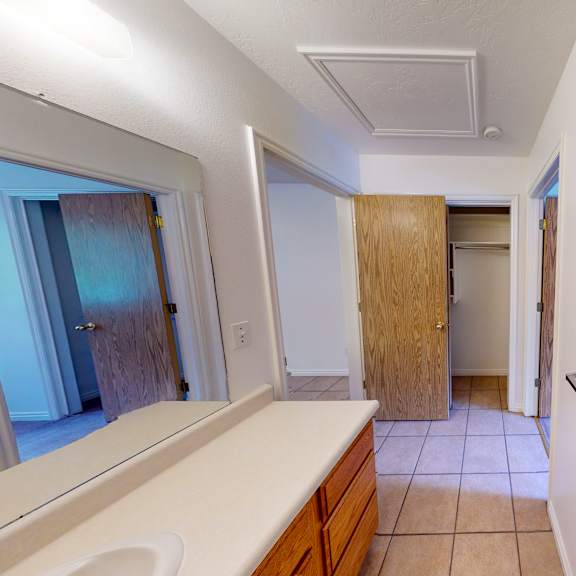 a bathroom with a sink, toilet and a window.