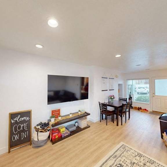 a living room with a sign that says "welcome come on in!".