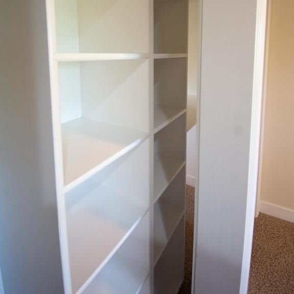empty white shelves in a room.