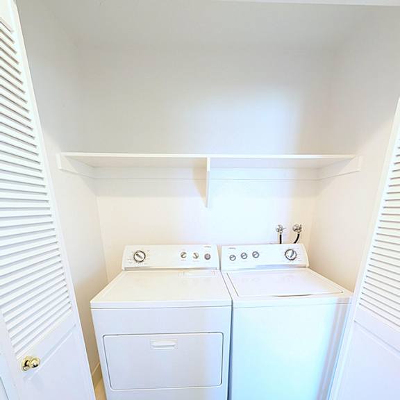 a small laundry room with a washer and dryer.
