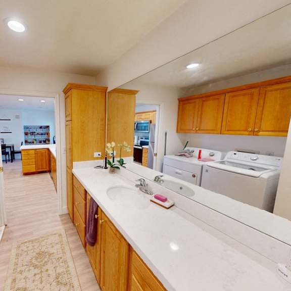 a kitchen with wooden cabinets and white countertops.