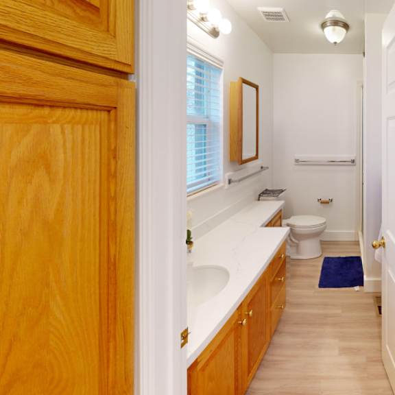 a bathroom with a toilet, sink, and bathtub.