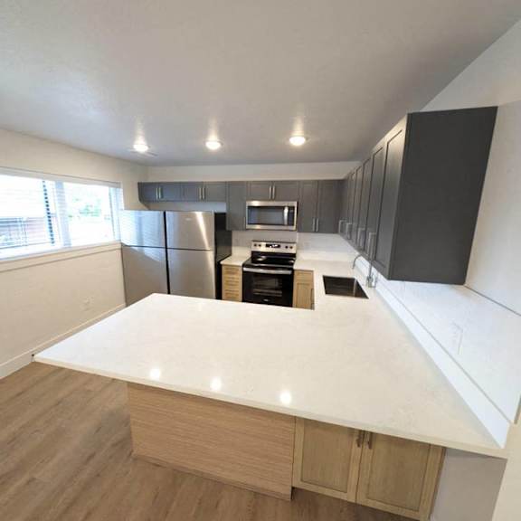 an empty kitchen with an island in the middle