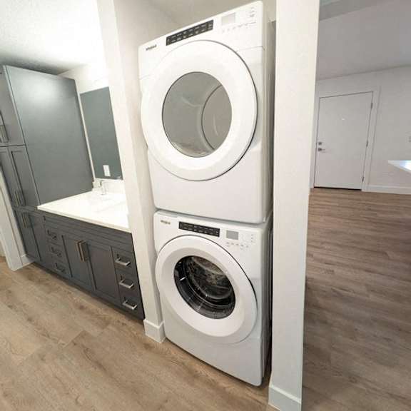 a front loading washer and dryer in a laundry room