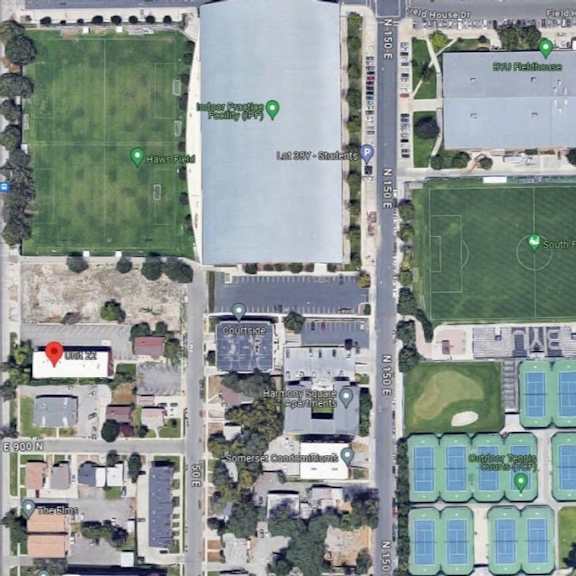 an aerial view of a sports field and a parking lot