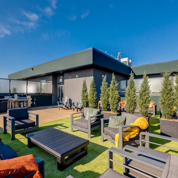 a patio area with a table, chairs, and couches.