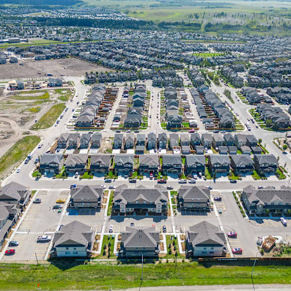 an aerial view of a neighborhood of houses in a parking lot