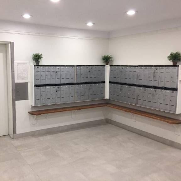 a locker room with lockers and plants on the wall