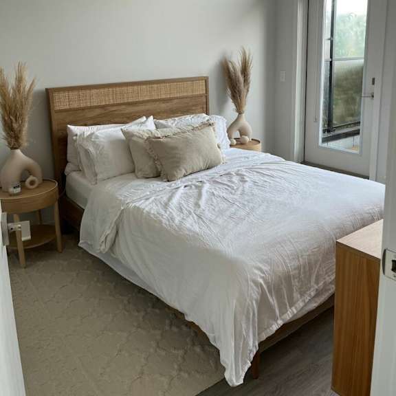 a bedroom with a bed and a window