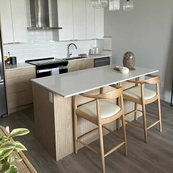 a kitchen with a center island next to a stove top oven