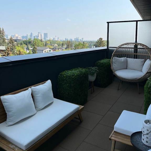 a balcony with a chair and a table