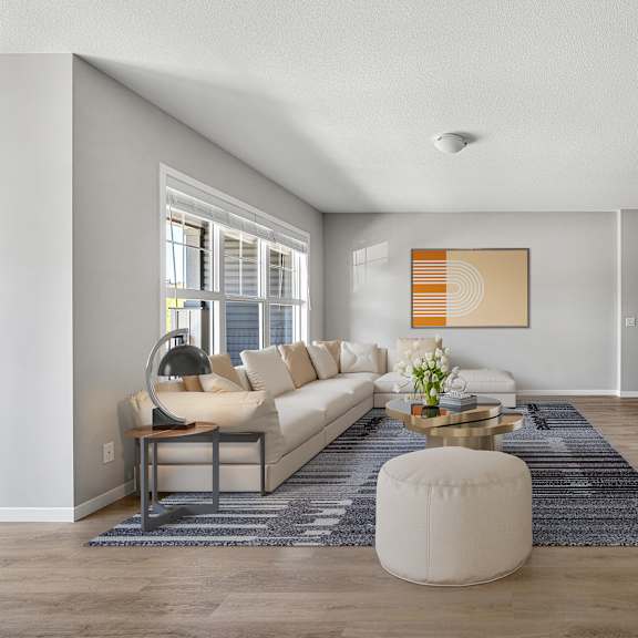 a living room with a white couch and a television