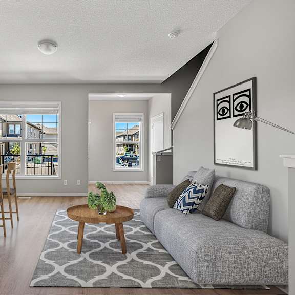 a living room and dining room with a couch and a table