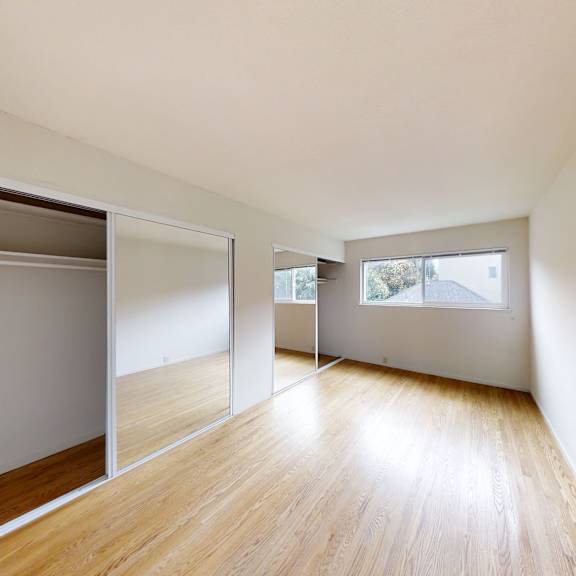 a room with wooden floors and white walls.