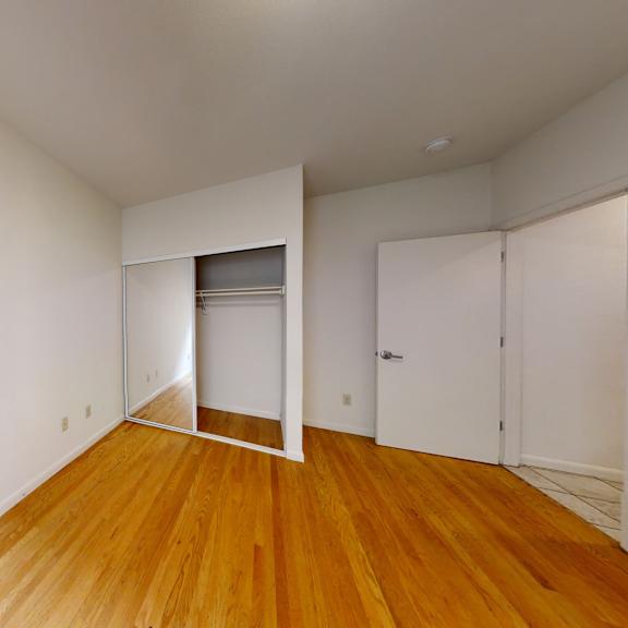 a room with wooden floors and white walls.