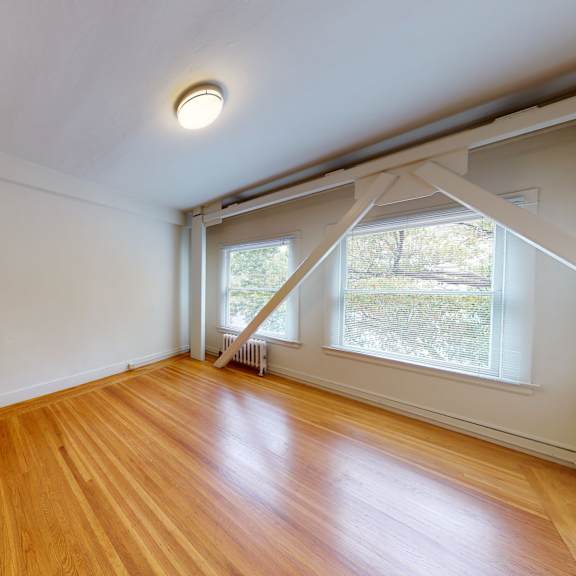 a room with wooden floors and white walls.