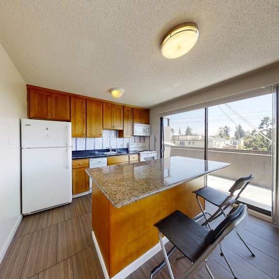 a kitchen with a white refrigerator and wooden cabinets.
