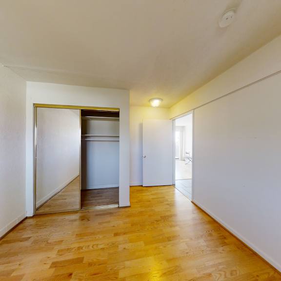 a long hallway with a door at the end.