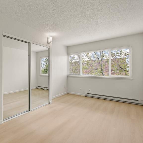 a room with a sliding glass door leading to a balcony.