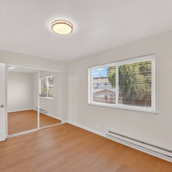 a room with a window and a radiator on the wall.