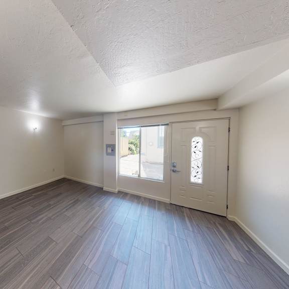 a room with a wooden floor and white walls.