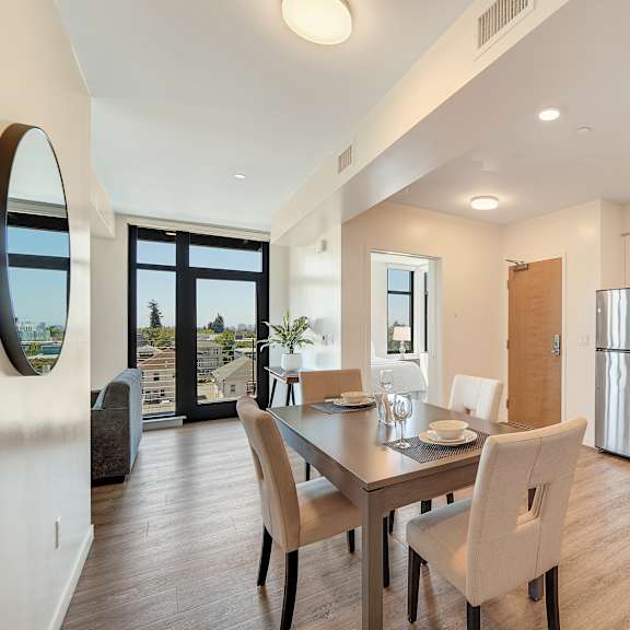 a modern kitchen with a dining table and chairs.