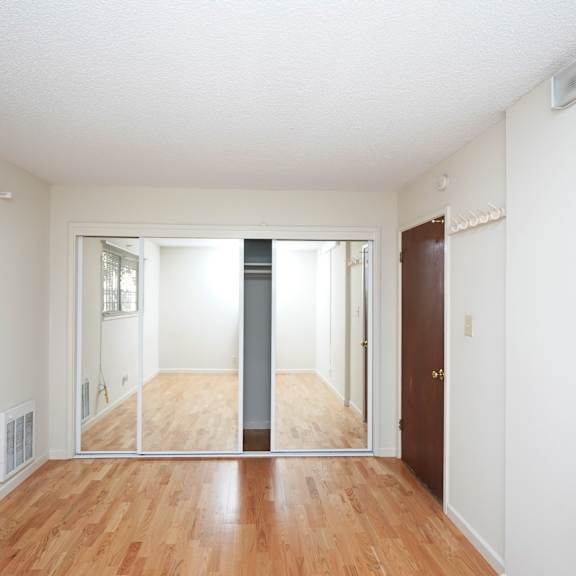 a room with a wooden floor and white walls.