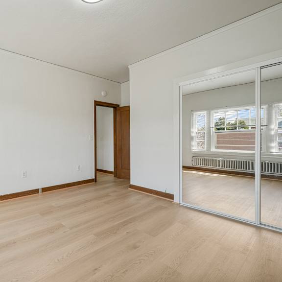 a room with a wooden floor and a sliding glass door.