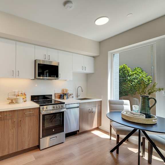 a modern kitchen with wooden cabinets and stainless steel appliances.