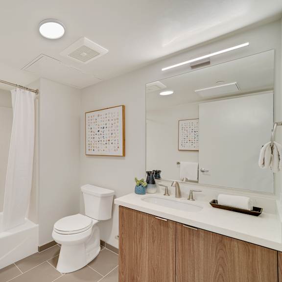 a white bathroom with a toilet, sink, and bathtub.