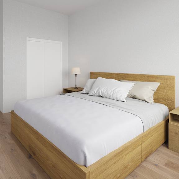 a bed with a white sheet and two white pillows sits in a room with wooden floors.