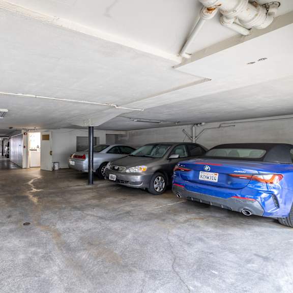 a parking garage with several cars parked inside.