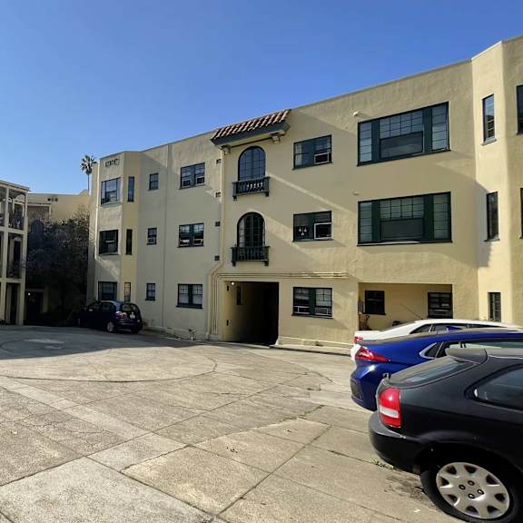 a parking lot in front of an apartment building