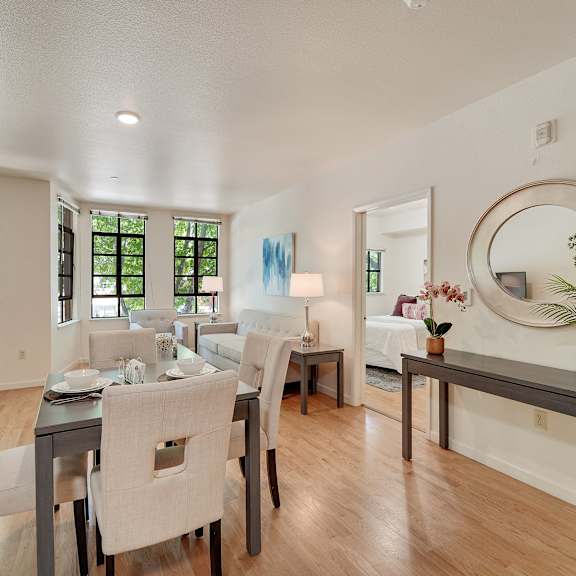 a dining room with a table set for six.