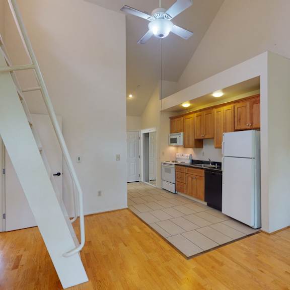 a white refrigerator is in a kitchen with wooden cabinets.