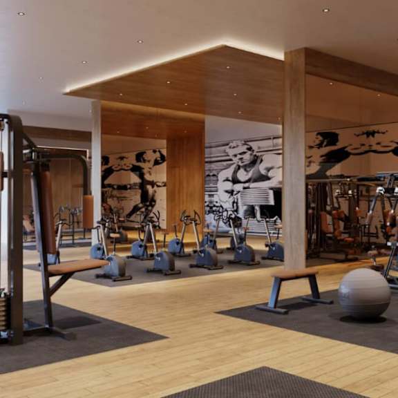 a gym with a variety of equipment including weights and exercise machines.
