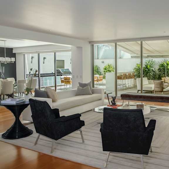 a living room filled with furniture and large windows