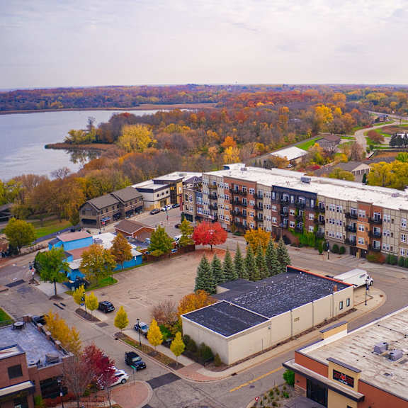an aerial view of an apartment complex with a river in the background